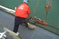 [ Photograph: Crew Stands By to release coupling ]