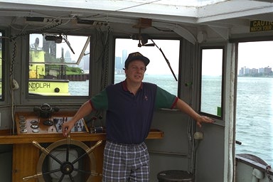 Photo: Captain at the wheel in pilothouse 