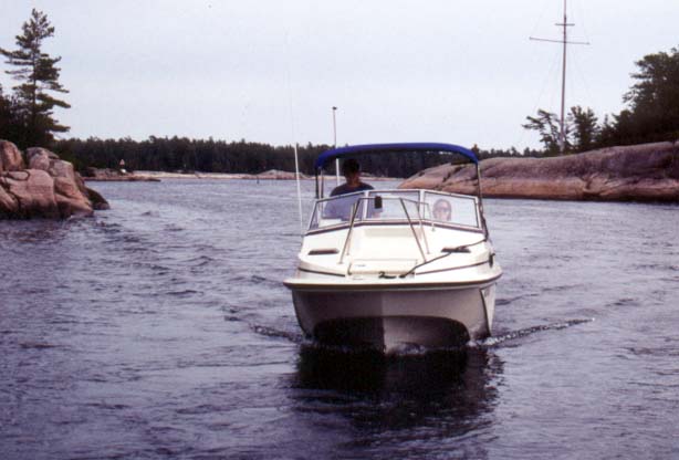 [Photo: Boston Whaler 20-Revenge slow speed in channel.]