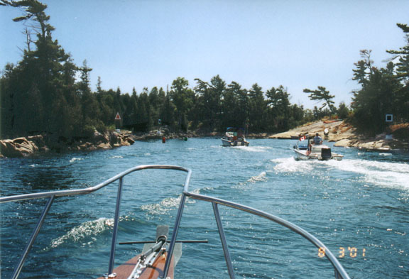 [Photo:three boats approaching tight turn]