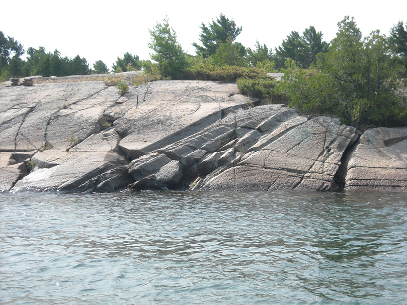 Photo: Shoreline rock with glacial ruts, Byng Inlet, Ontario.