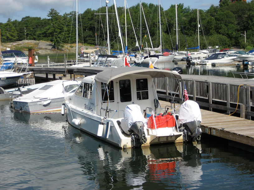 Photo: Twin engine catamaran with missing gear cases on both outboard motors Killbear Marina, Parry Sound region, Ontario.