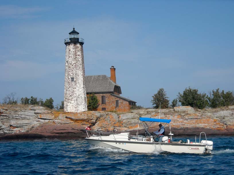Photo: Boston Whaler 25-foot OUTRAGE CUDDY at Isle Royale Lighthouse, Lake Superior.