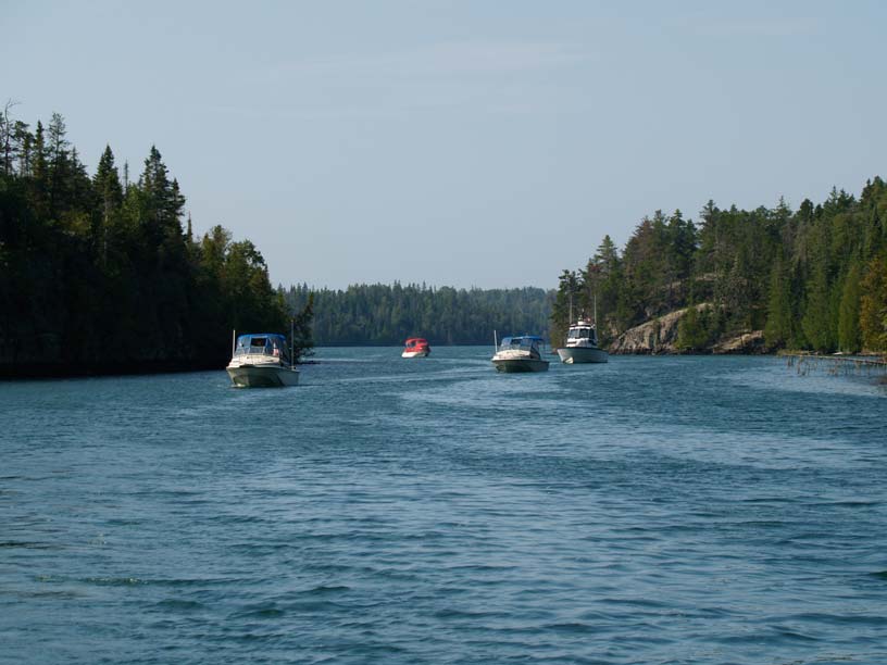 Photo: Four Boston Whaler boats exiting Chippewa Harbor, Isle Royale, Lake Superior.