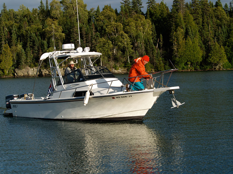 Photo: Boston Whaler boat goes to anchor in Chippewa Harbor, Isle Royale, Lake Superior.