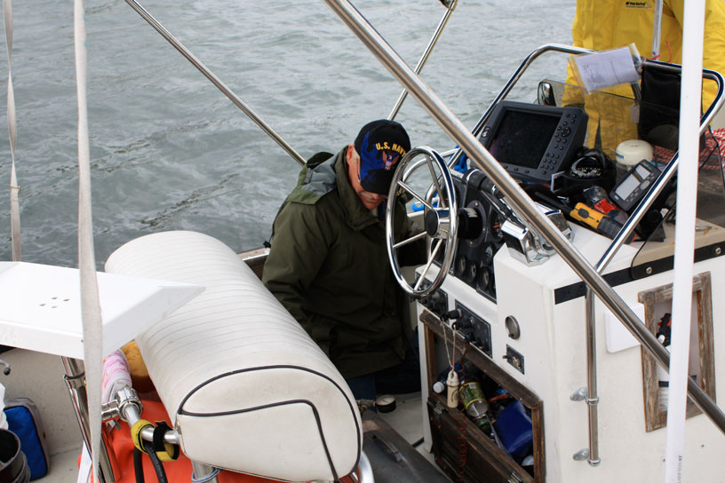 Photo: Thor at helm of INVICTUS, Mott Island, Isle Royale, Lake Superior.