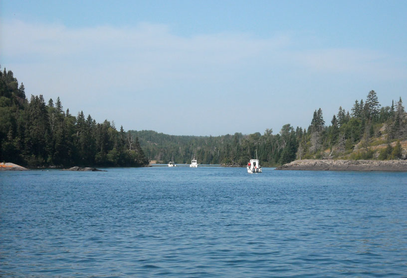 Photo: Three boats enter Chippewa Harbor, Isle Royale National Park.