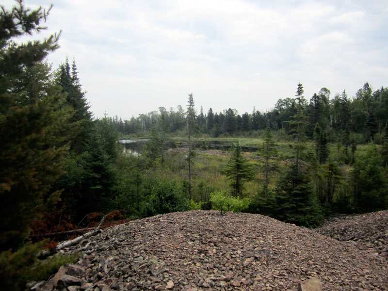 Photo: Piles of broken rock or mine tailings at the Minong Mine, Isle Royale National Park.