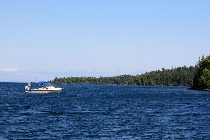Photo: Boston Whaler boat on deep blue Lake Superior water.