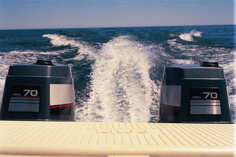 [Photo: View over transom of CONTINUOUSWAVE in mid lake.]