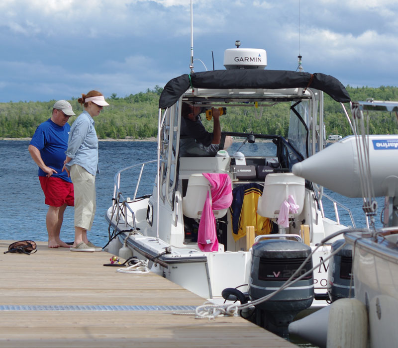 Photo: Repairs to windshield of HOLLY MARIE at the dock at Meldrum Bay, Manitoulin Island, Ontario