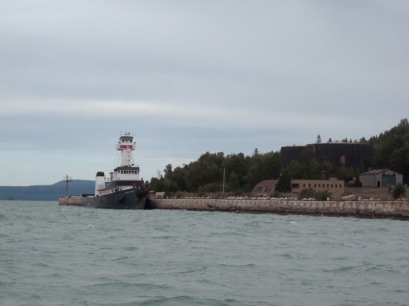 Photo: 150-foot tug tied to outer face of dock at Lime Island, Michigan