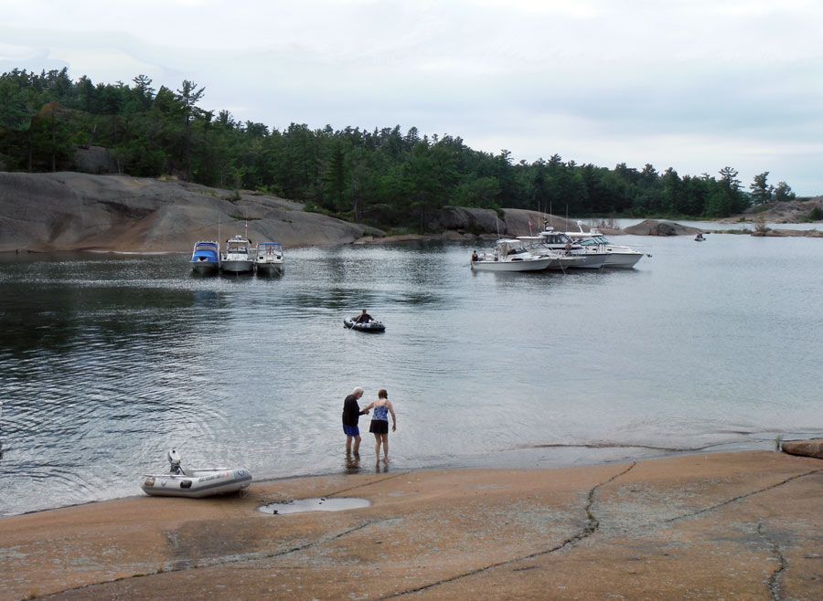 Photo: view of cove on South Benjamin Island, with two rafts of boats at anchor
