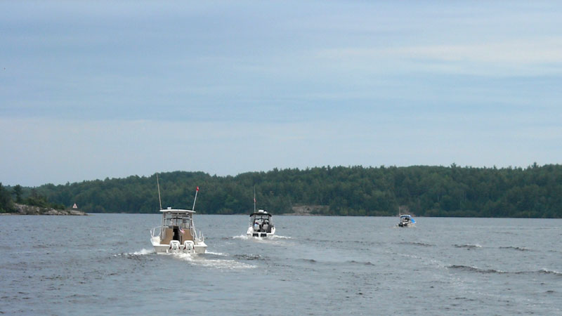 Photo: Line of boats approaching turn to Little Detroit, Whalesback Channel, Aird Island east end.