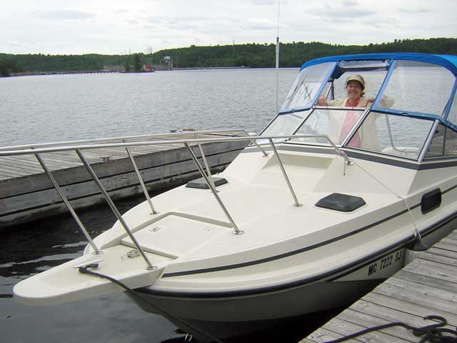 Photo: Boston Whaler Revenge 22 back in water after launch; hydro-electric dam in background.