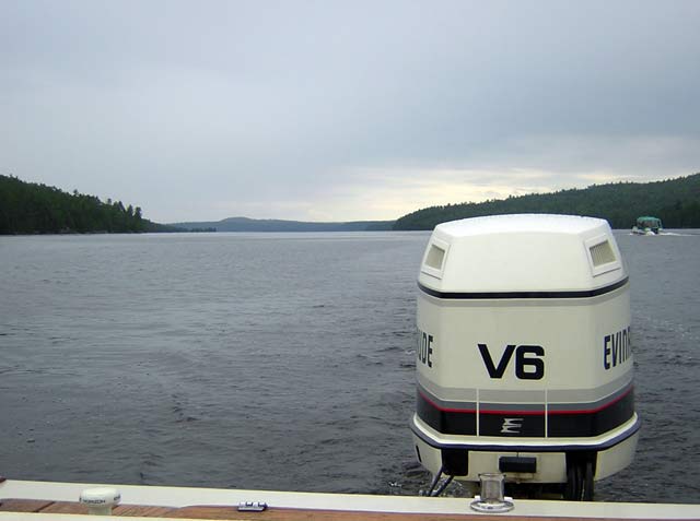 Photo: Pontoon Boat Passing By, Clouds