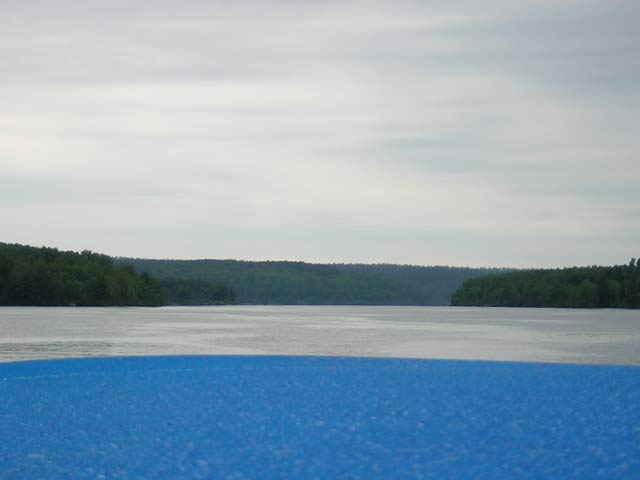 Photo: View over rain-soaked canvas of river and shore
