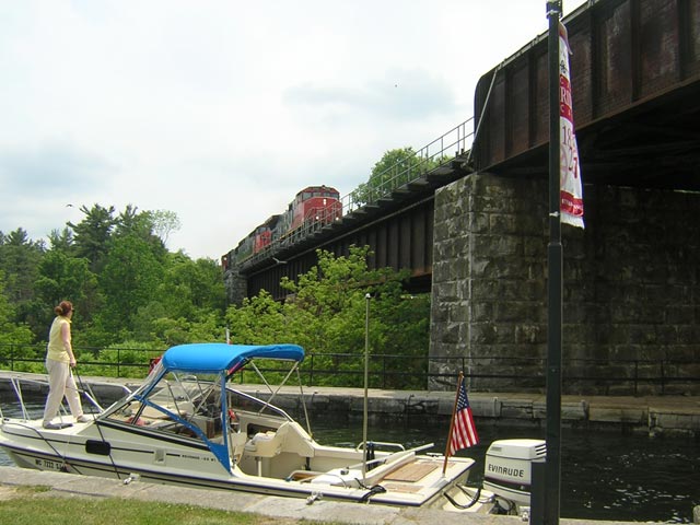 Photo: Heavy freight train come over railroad bridge across canal
