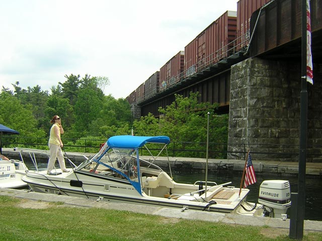 Photo: Heavy freight train come over railroad bridge across canal