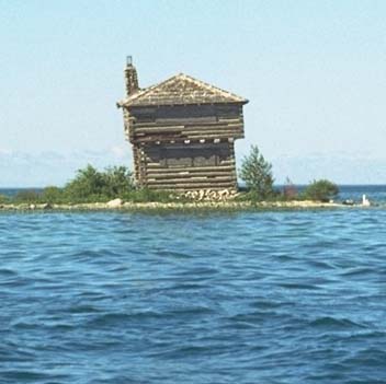 Photo: a very old log lighthouse structure.