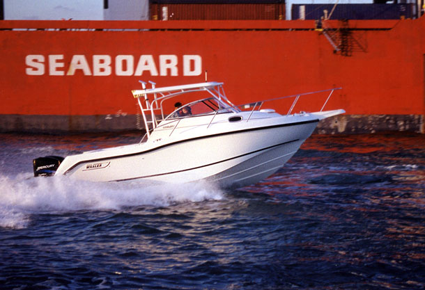 Photo: Boston Whaler 2002 255 CONQUEST on plane with twin engines; red freighter hull in background