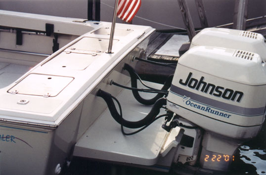 Photo: Close up of transom of Whaler 27 with Salt Shaker Marine Fiberglass Bracket and twin outboards