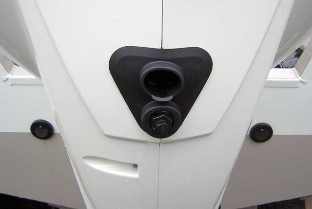 [Photo: Evinrude 225-HP E-TEC Outboard close-up flush port and tell tale.]