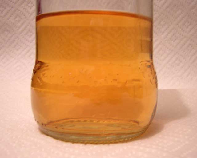 Photo: Close-up of fuel sample showing no phase boundary in solution.