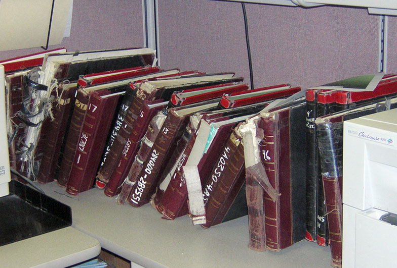[Photo: Old books of factory records.]