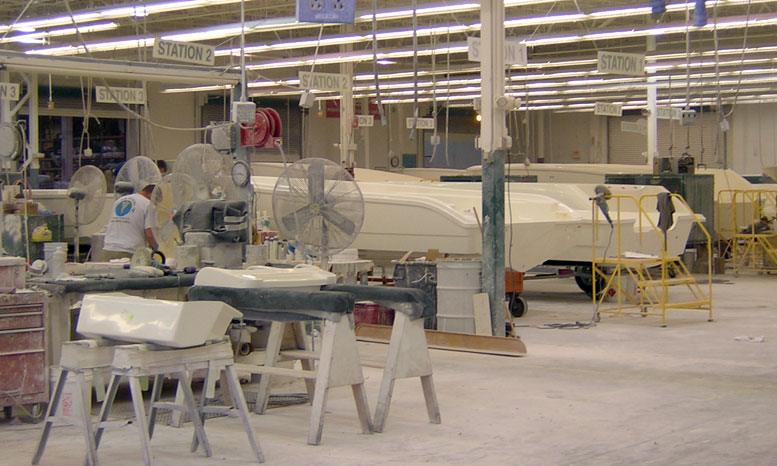 [Photo: Hulls at first step of assembly line.]