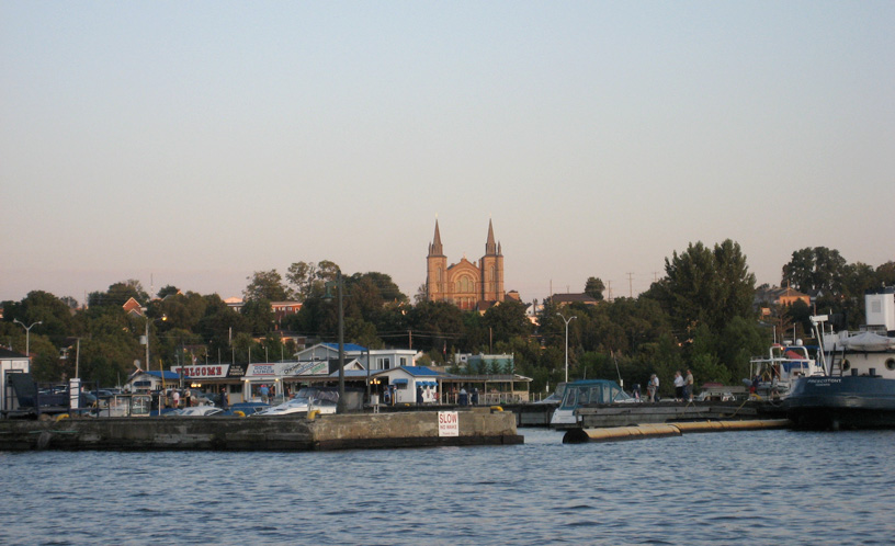Photo: Dock and church at Penetanguishene, Ontario, seen from the harbor.