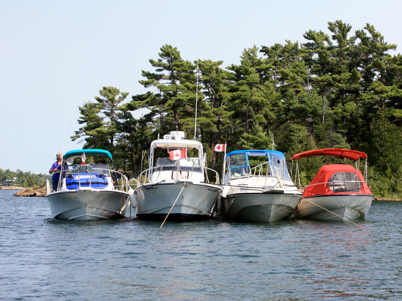 Photo: Four Boston Whaler boats rafted for lunch in wilderness anchorage, Georgian Bay.