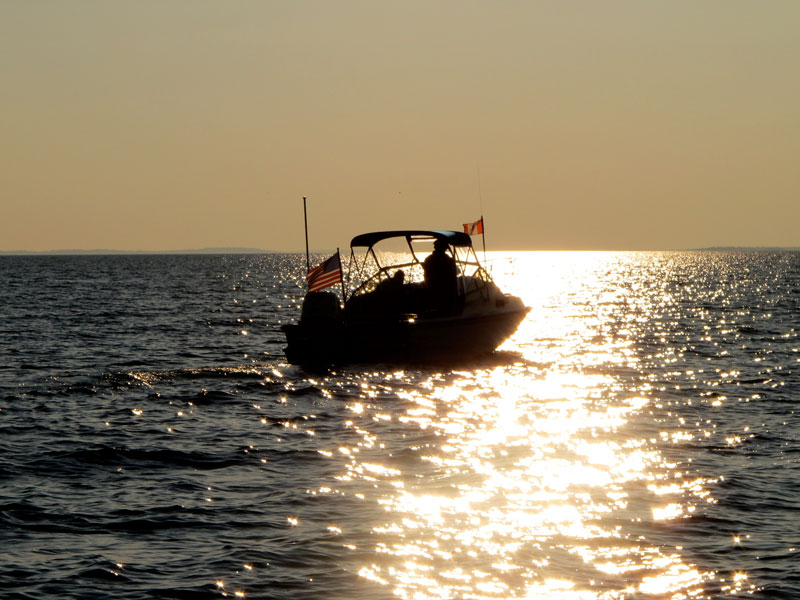 Photo: Boston Whaler REVENGE 22 W-T Whaler Drive heading West into setting sun; golden silhouette.
