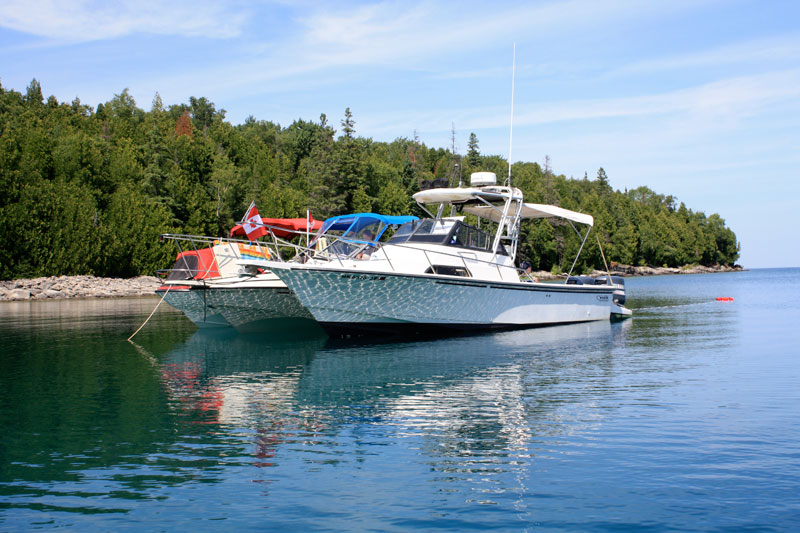 Photo: Three Boston Whaler boats at anchor in remote cove, Cove Island, Georgian Bay, Lake Huron.