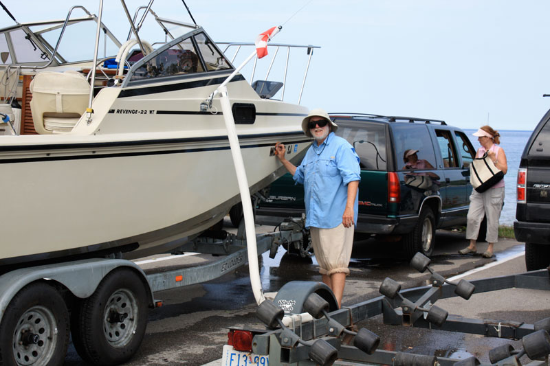 Photo: Boat on trailer and hull being washed.