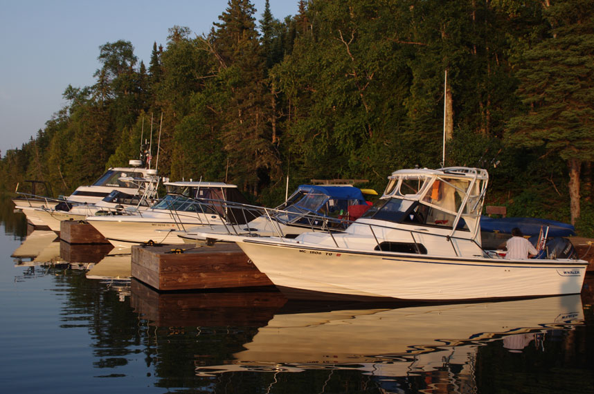 Photo: Five boats at dock at Tobin Harbor, bows pointed to the West.