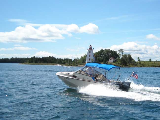 Photo: Lighthouse at Strawberry Island with HOME ASIDE in foreground.