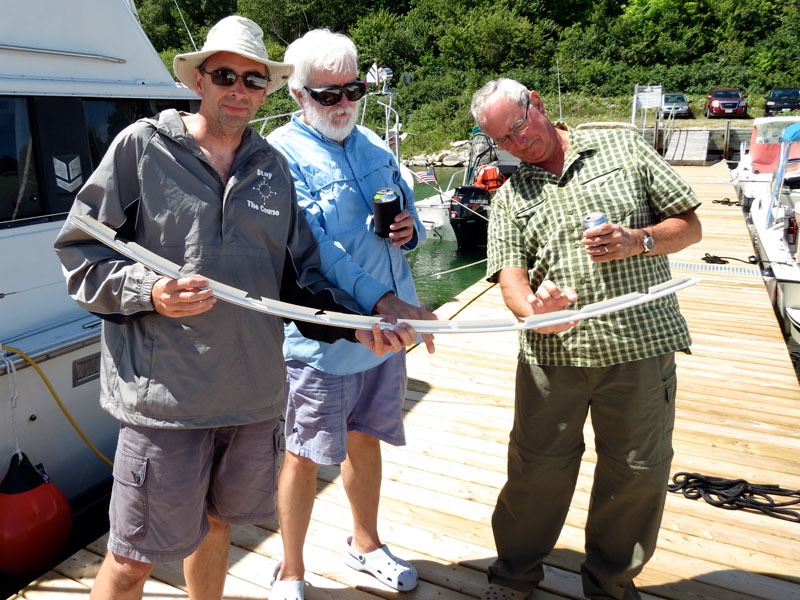 Photo: Three captains inspect damaged canvas fitting.