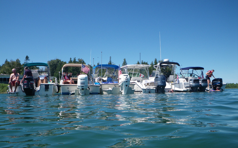 Photo: Six-boat raft as seen from astern at water level.