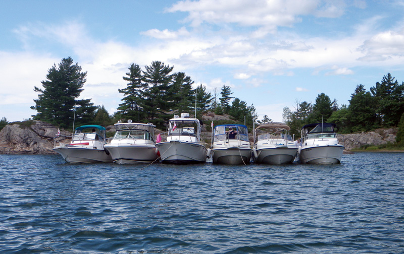 Photo: Six boats rafted at anchor in Long Point Cove.