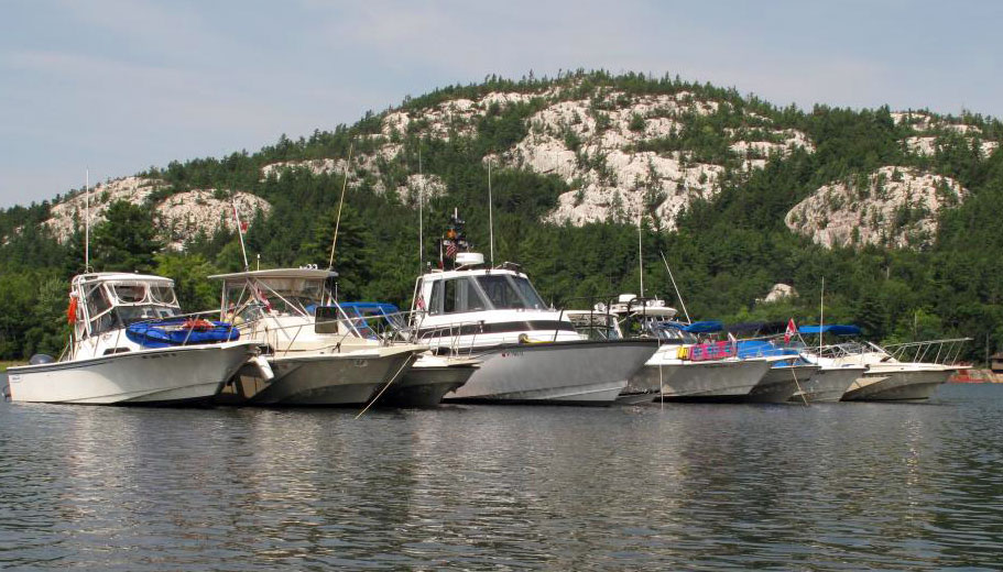 Photo: View of nine boats rafted at anchor in The Pool