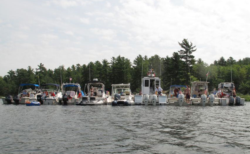 Photo: View of nine boats rafted at anchor in The Pool