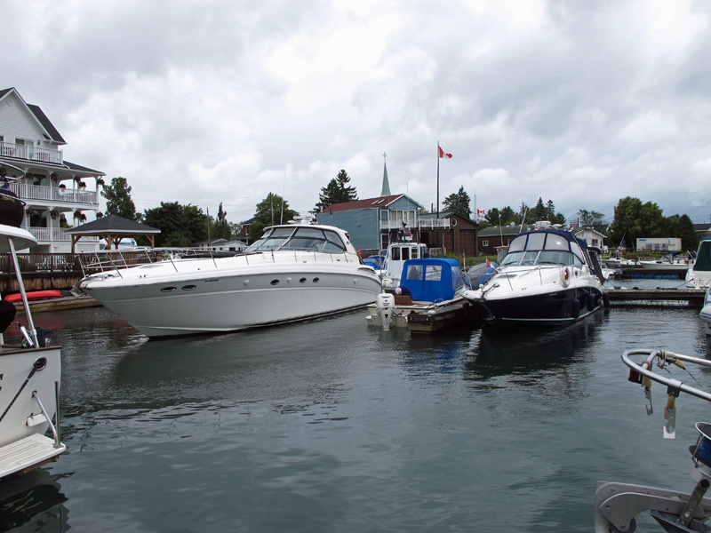 Photo: Two large boats are in the slips adjacent to the much smaller boat CONTINUOUSWAVE