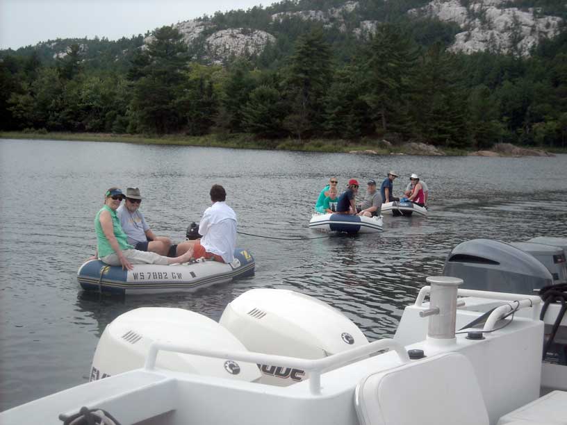 Photo: Two dinghies towed by a third dingy with engine