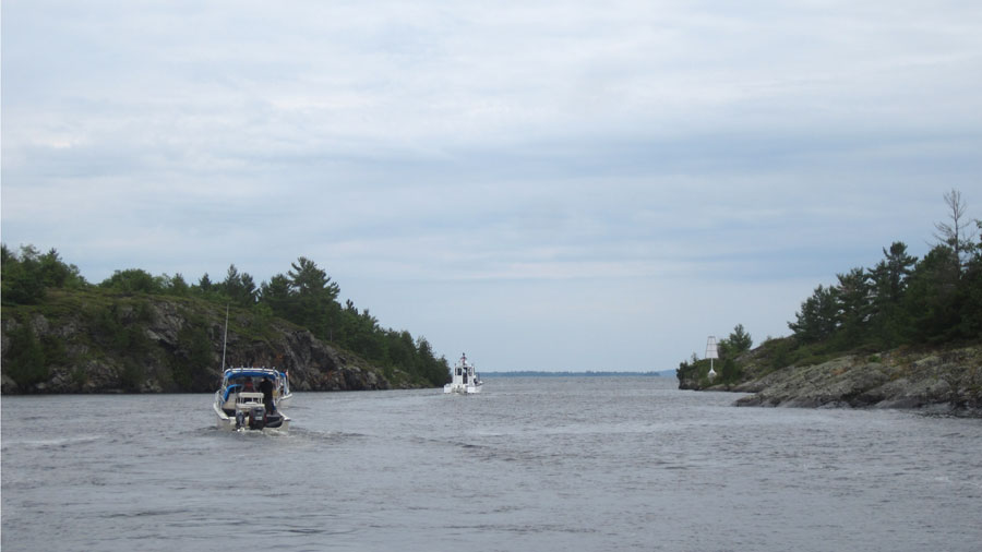 Photo: Line of boats transiting Little Detroit, Whalesback Channel, Aird Island east end.