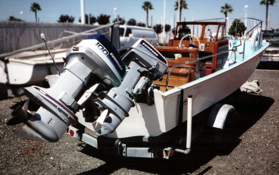 [Photo: Boston Whaler 16-Sakonnet on trailer with main and auxillary outboards.]