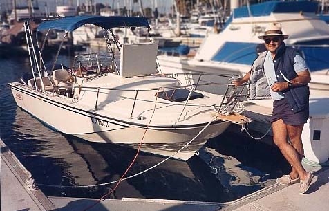 Photo: 1986 22-Outrage Cuddy at dock with owner Mario Cano 