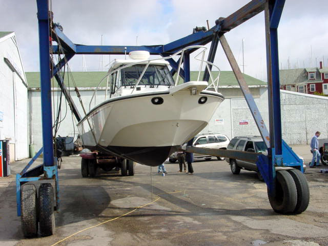 Photo: 27 Offshore with twin OMC outboards hanging in Travel Lift