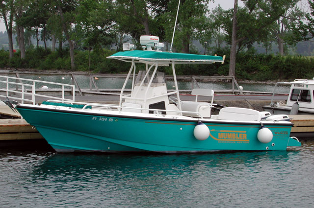 Photo: 1996 24-Outrage at dock; aqua hull gelcoat and matching canvas