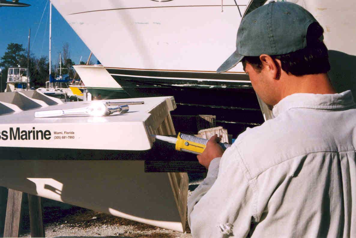 Photo: Mark Bragg applying caulk to Stainless Marine bracket during installation
